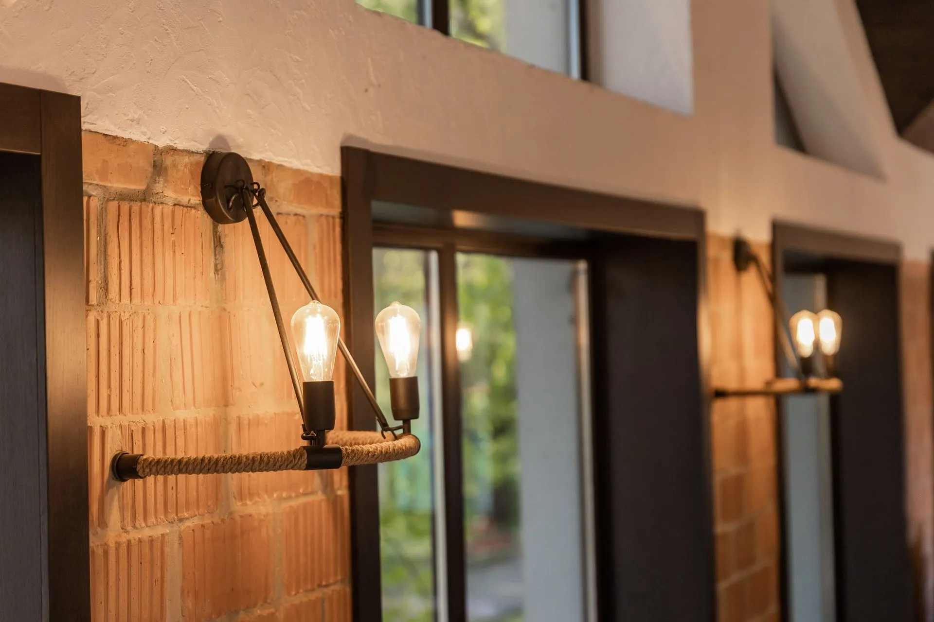 Vintage Edison-bulb pendant fixture mounted on an exposed brick wall