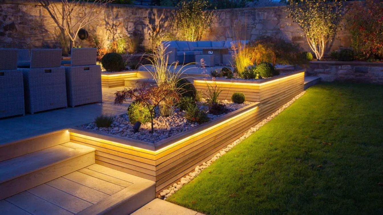 Landscape and outdoor accent lighting installed on a modern home at dusk